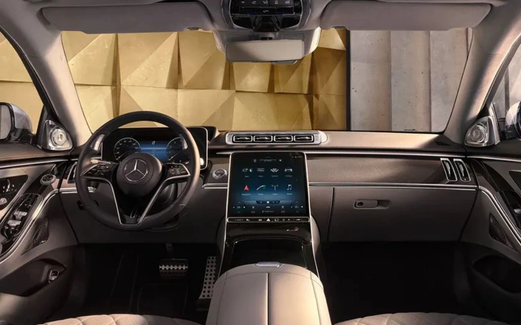 Luxury car interior with modern dashboard and large touchscreen display.
