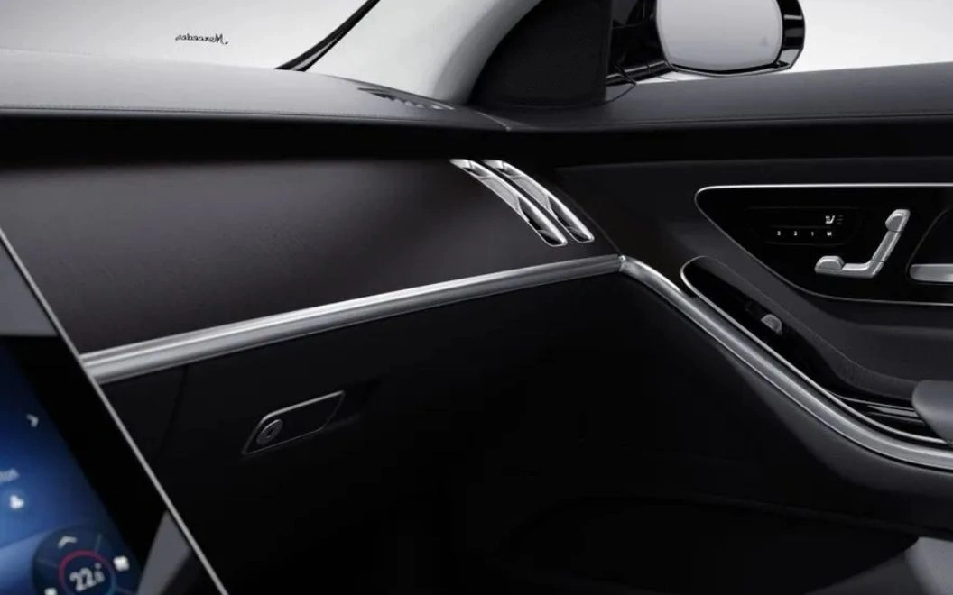 Close-up of a sleek car interior focusing on the dashboard and door panel.