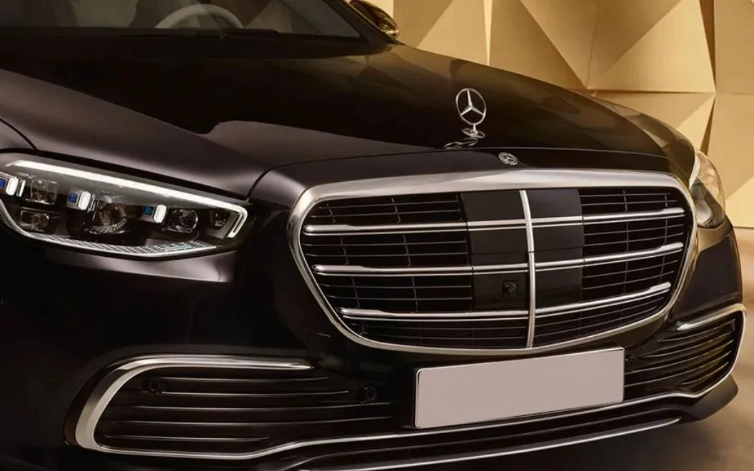 Close-up of a black Mercedes-Benz grille with emblem.