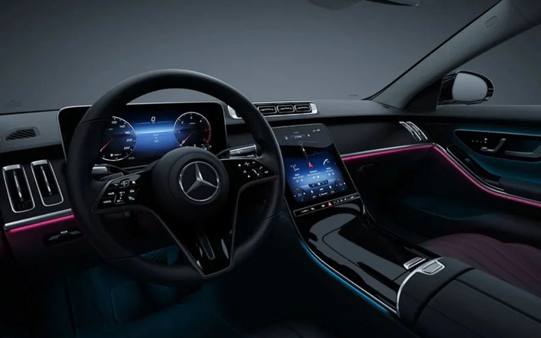 Luxurious Mercedes-Benz interior with high-tech digital displays and ambient lighting.