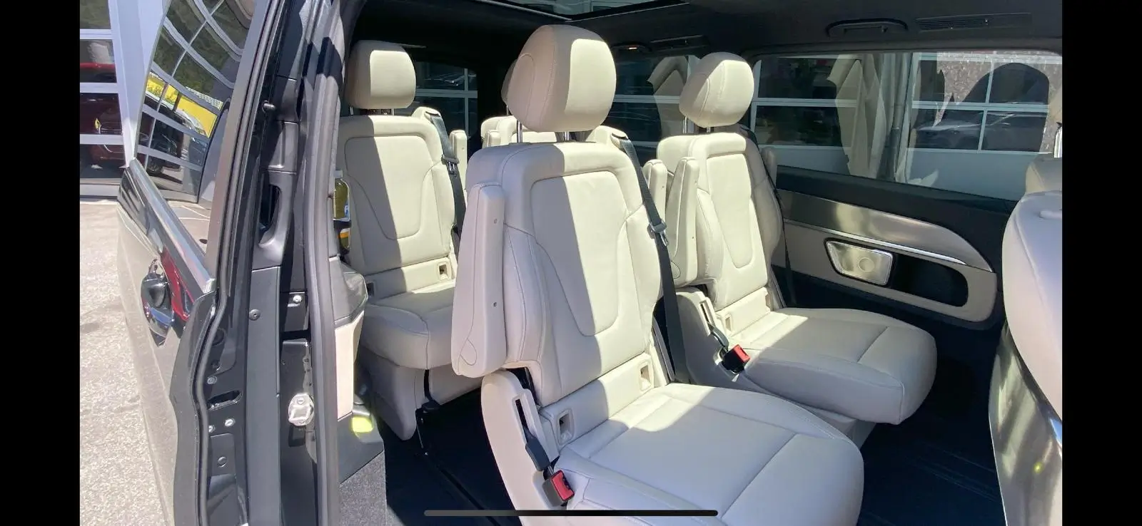 Luxurious white leather seats inside a vehicle.